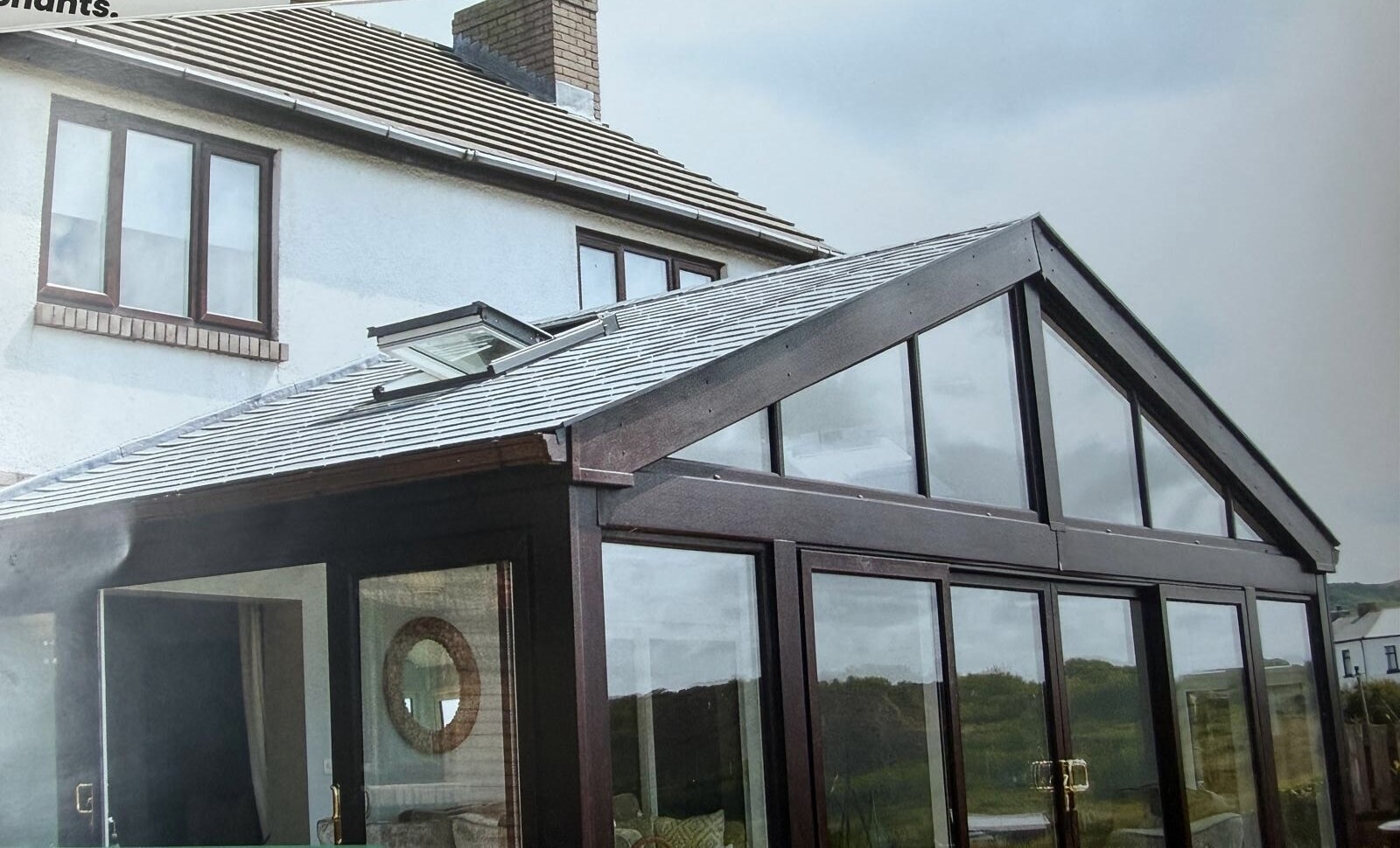 A lightweight tiled finish with retained glazed gable panels.